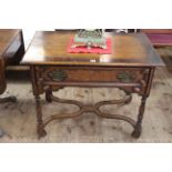 Oak single drawer lowboy raised on four turned legs joined by scrolled stretchers,