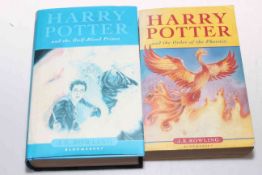 Two Harry Potter books, First Edition Half Blood Prince with dust cover and another.