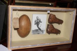 Cased Johnny Lujack America Football boots and ball.