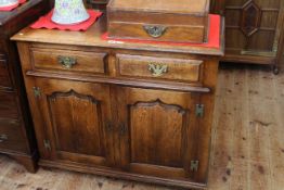 Period style oak dresser having two drawers above two arched fielded panel doors,