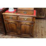Period style oak dresser having two drawers above two arched fielded panel doors,