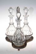 Silver plated decanter stand with three glass decanter bottles, 40cm high.