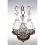 Silver plated decanter stand with three glass decanter bottles, 40cm high.