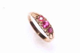 9 carat gold and three stone ruby ring, hallmarked for Birmingham 1979, size I/J.