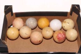 Eleven antique ivory billiard balls.