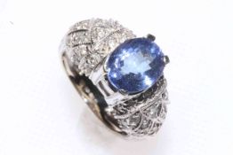 14 carat white gold, blue (topaz) stone and diamond set ring with fancy shoulders, size L/M.