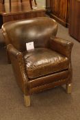 Small brown leather and studded tub armchair.