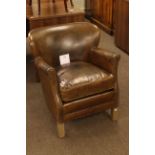 Small brown leather and studded tub armchair.