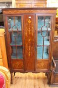 Edwardian inlaid mahogany two door vitrine on square tapering legs to spade feet,