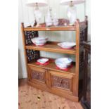 Victorian mahogany buffet having three open shelves with fretwork panelled sides above two carved