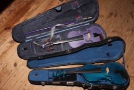 Two cased violins with one bow.