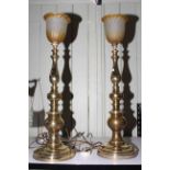 Pair of brass column table lamps with amber glass shades, 74cm high.