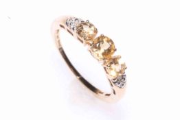 9 carat gold three yellow stone ring with tiny diamond set shoulders, size O.