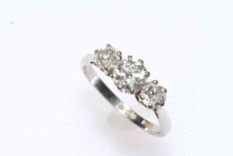 Platinum set three stone diamond ring, the centre approximately 0.