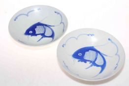 Two Chinese fish decorated shallow dishes, 23cm diameter.