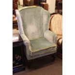 Georgian style wing back armchair in green draylon.