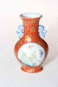 Small Chinese two handled vase having two panels of birds with blossom and butterflies on red and