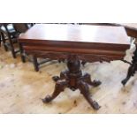 Victorian mahogany fold top tea table on turned pedestal to four scrolled legs,