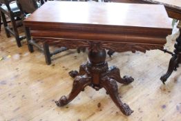 Victorian mahogany fold top tea table on turned pedestal to four scrolled legs,