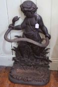 Cast stick stand modelled as a child grasping a serpent, 81cm high by 47cm wide by 24cm deep.