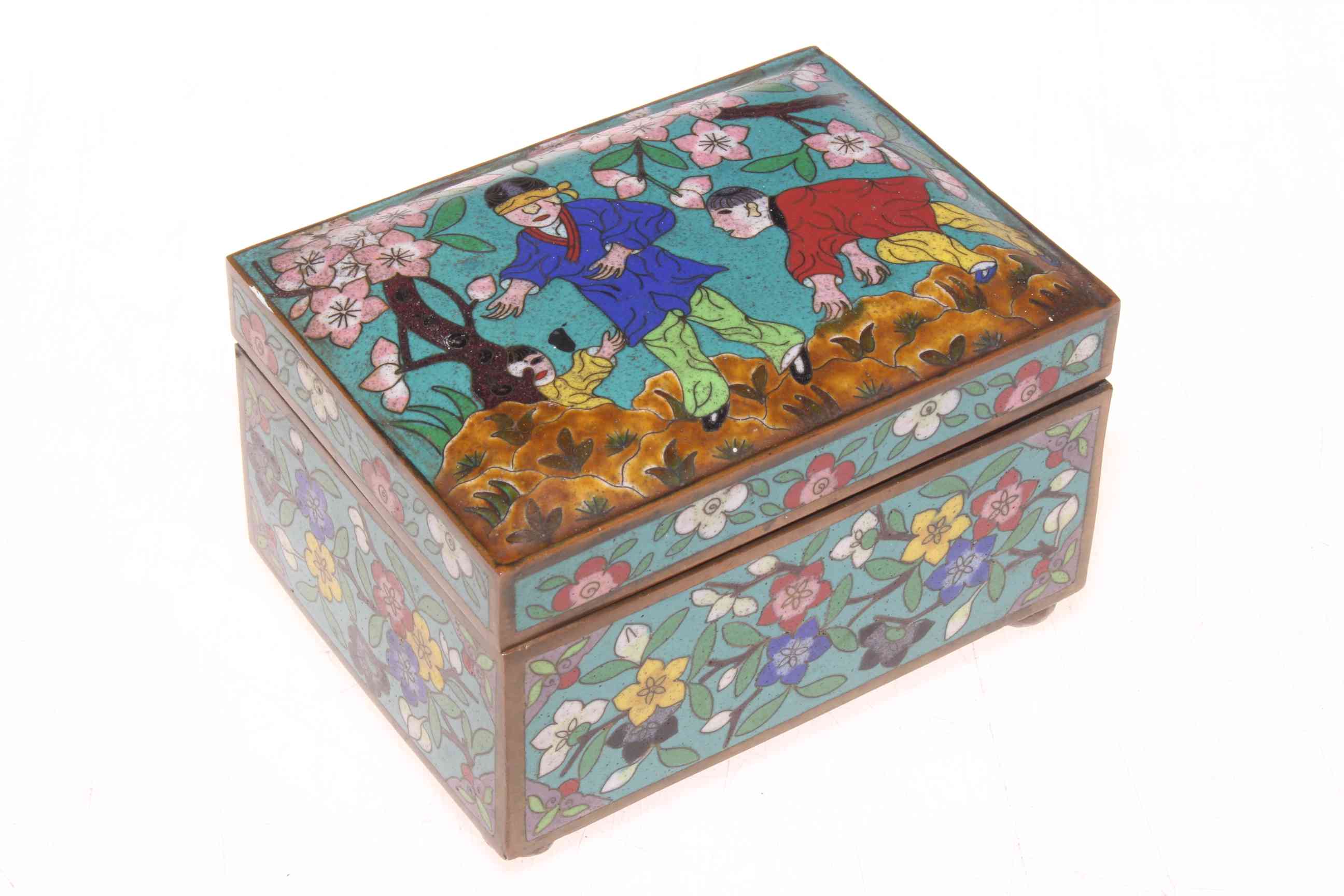 Cloisonne box, the lid with children playing hide and seek, 72cm wide.