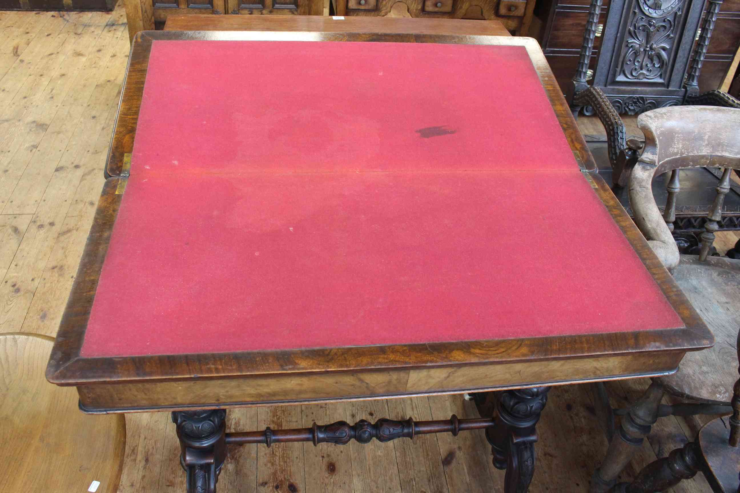 Victorian walnut fold top card table raised on turned carved pillars to four scrolled legs joined - Image 2 of 2