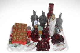 Tray lot with Oriental decorative figures, lion, Buddha, china boxes and banner.