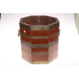 Octagonal mahogany and brass bound two handled coal bucket, 34cm high.