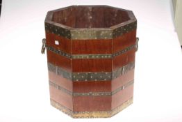 Octagonal mahogany and brass bound two handled coal bucket, 34cm high.