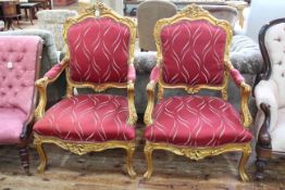 Pair gilt framed open armchairs with serpentine front seats.