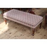 Rectangular tapestry footstool on turned fluted legs, 37cm high by 104cm wide by 47cm deep.
