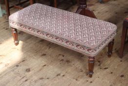 Rectangular tapestry footstool on turned fluted legs, 37cm high by 104cm wide by 47cm deep.