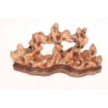 Unusual Chinese soapstone/coral style porcelain sculpture with shaped base and gilt mark,