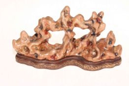 Unusual Chinese soapstone/coral style porcelain sculpture with shaped base and gilt mark,