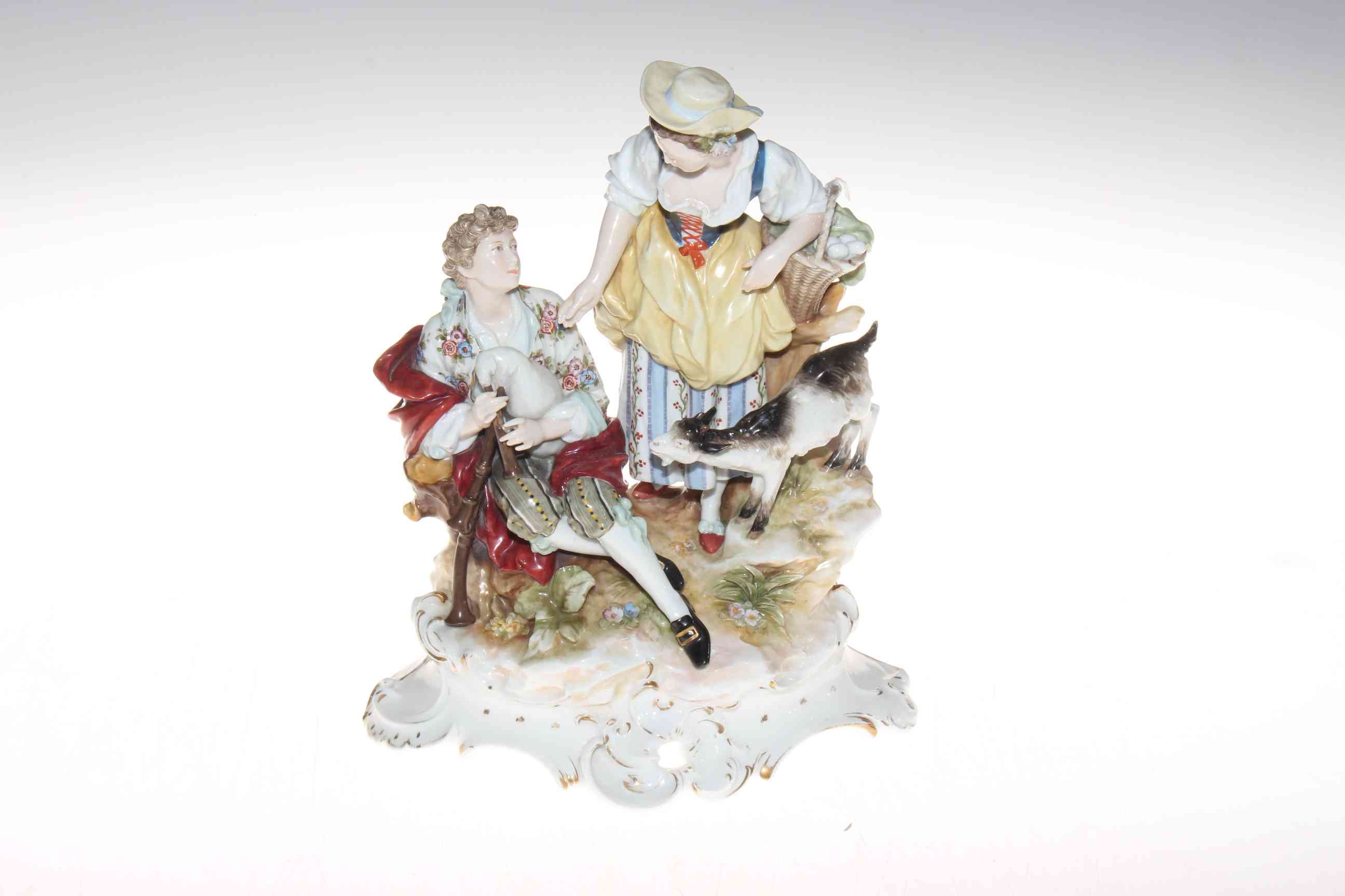 Continental porcelain pastoral group of piper and maiden, 26cm.