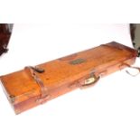 Leather and brass bound gun case, 81cm length.