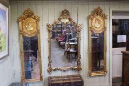 Pair rectangular gilt framed bevelled wall mirrors with relief portrait panels,