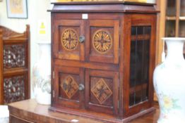 Arts & Crafts table cabinet having hinged lid with four doors below,