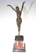 Art Deco style bronze lady figure in a dancing pose on marble plinth, 56cm high.