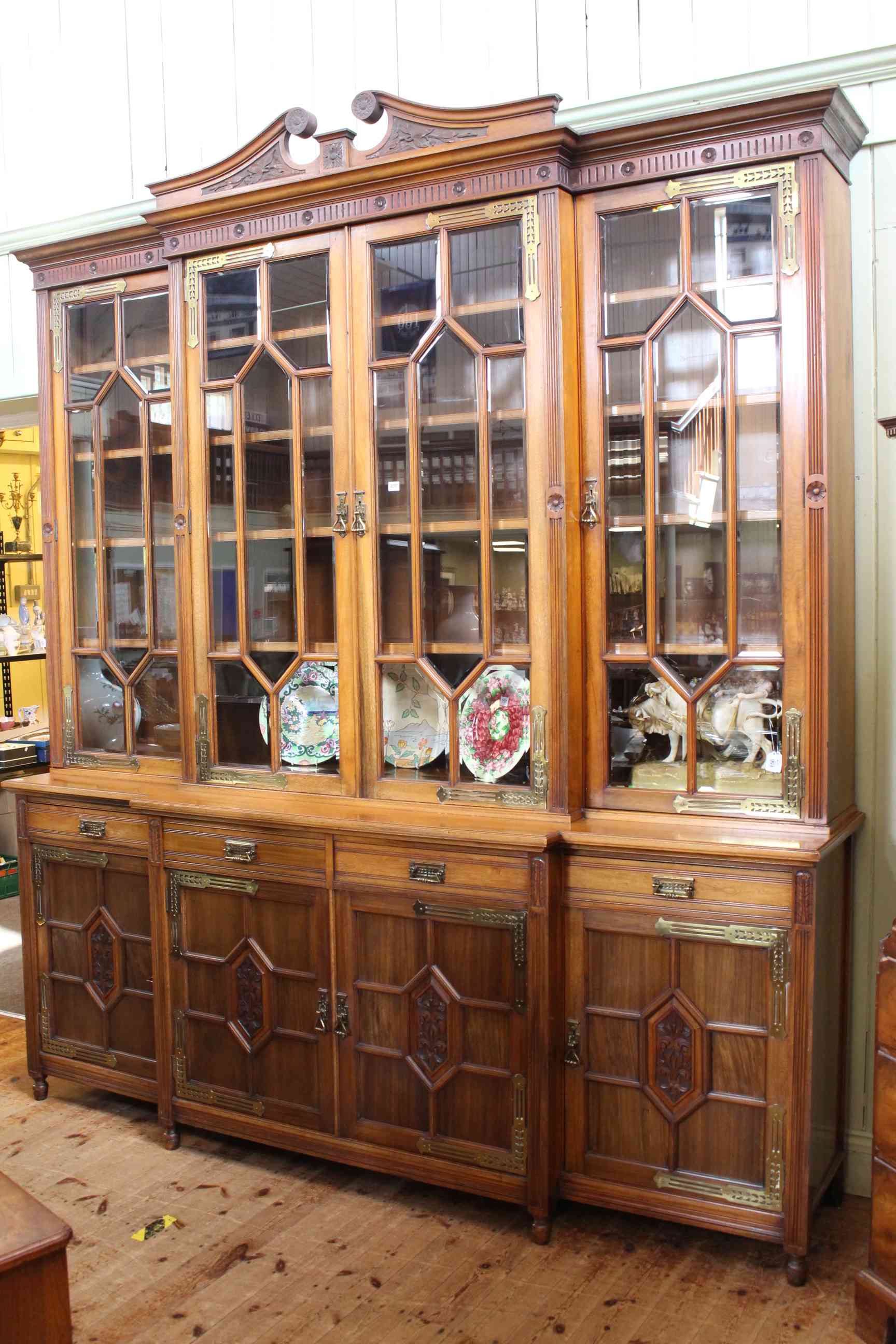 Impressive Victorian aesthetic breakfront library bookcase having swan neck pediment above four