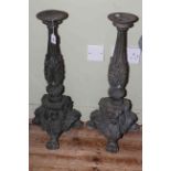 Pair of cast iron ornate column candle stands, 67cm high.