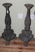 Pair of cast iron ornate column candle stands, 67cm high.