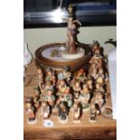 Collection of twenty five Hummel figures and a Hummel lamp,