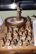 Collection of twenty five Hummel figures and a Hummel lamp,