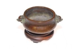 Small Chinese bronze censor with mask handles, mark to base, 8cm diameter, with stand.