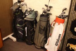 Four golf bags and collection of golf clubs including Slazenger, Dunlop, etc.