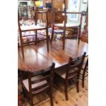Oval mahogany twin pedestal extending dining table and two leaves,