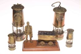 Collection of four miners lamps (two miniature) and coal truck ornament (5).