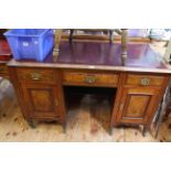 Late Victorian pedestal desk having three drawers above two cupboard doors,