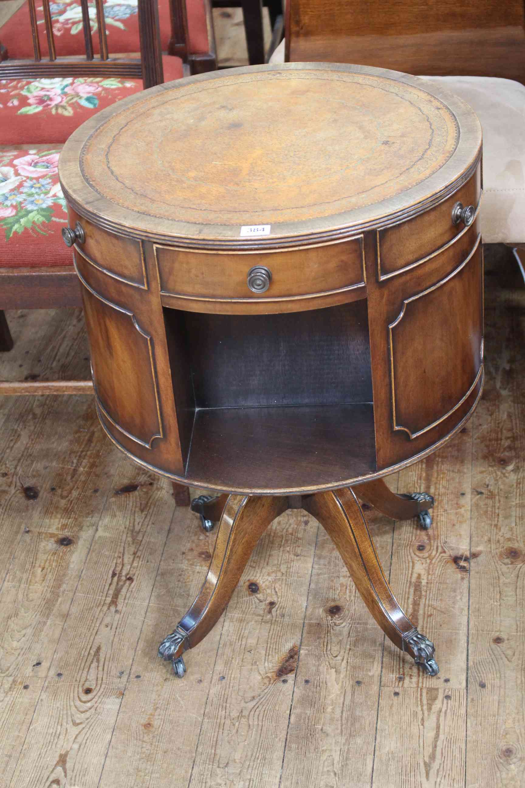 Mahogany revolving drum book table, 70cm high by 51cm diameter.